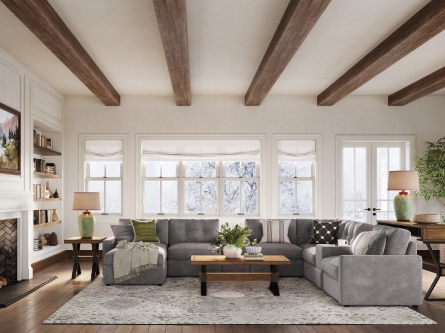 living room with a fireplace and wooden beams
