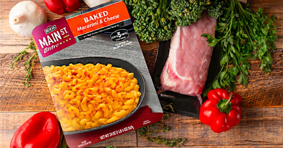reser's main st bistro mac and cheese box on cutting board with pork and veggies