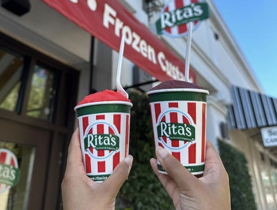 two hands holding up a rita's italian ice