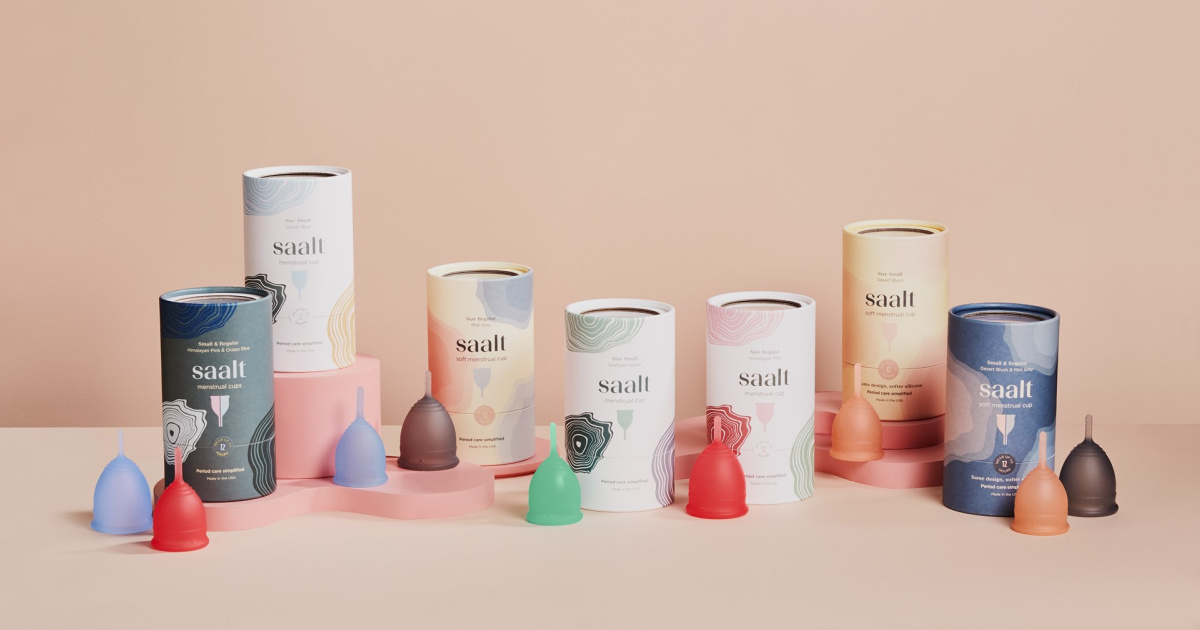 saalt menstrual cups lined up with their packaging against a beige background