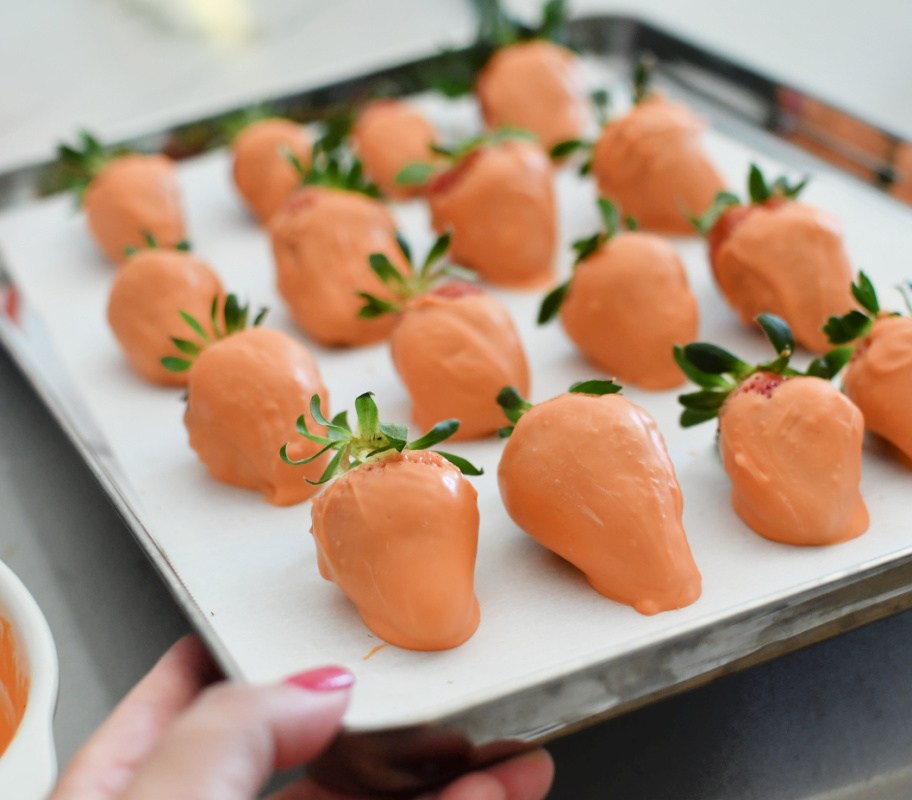 sheet pan with parchment paper and dipped strawberries