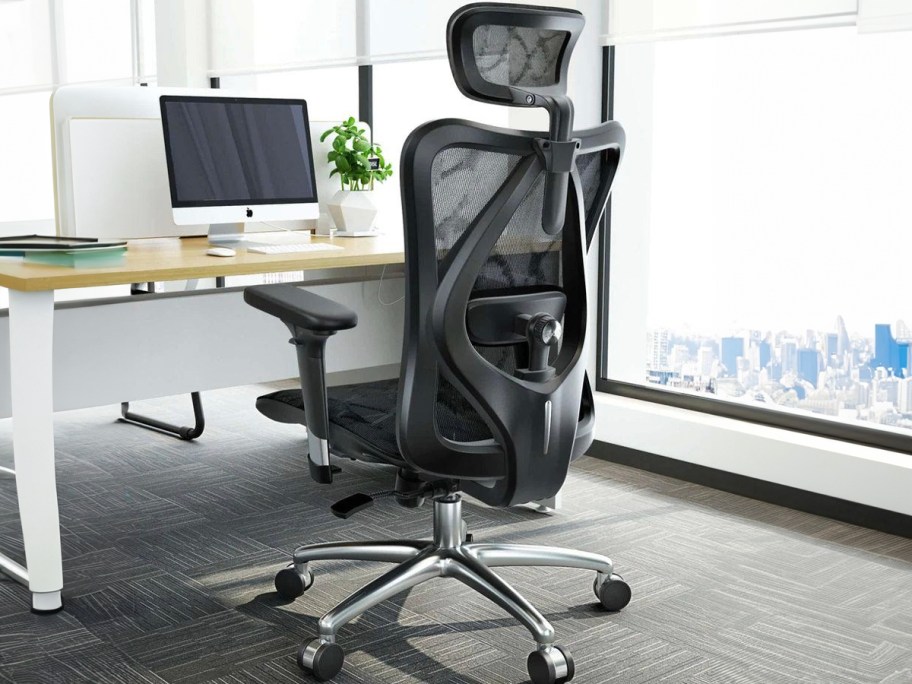 back of black office chair at desk