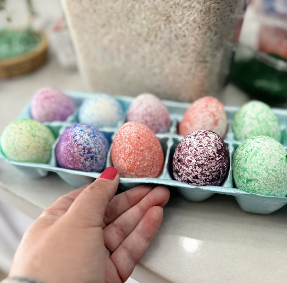 speckled easter eggs in an egg carton container after dying them