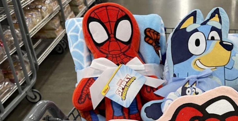 a spider-man blanket and pillow set in a shopping cart