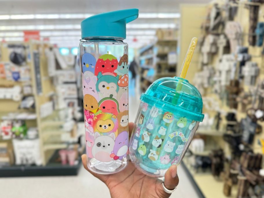 hand holding a Squishmallows plastic water bottle and tumbler
