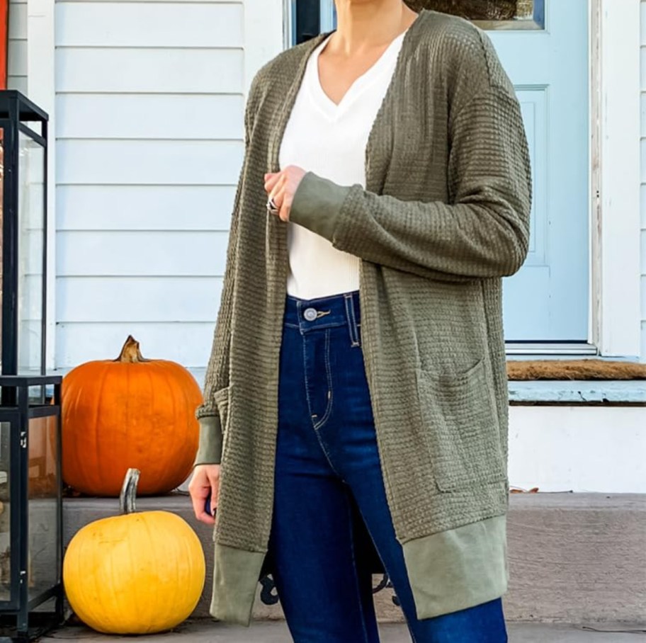 woman wearing green cardigan with jeans and white shirt