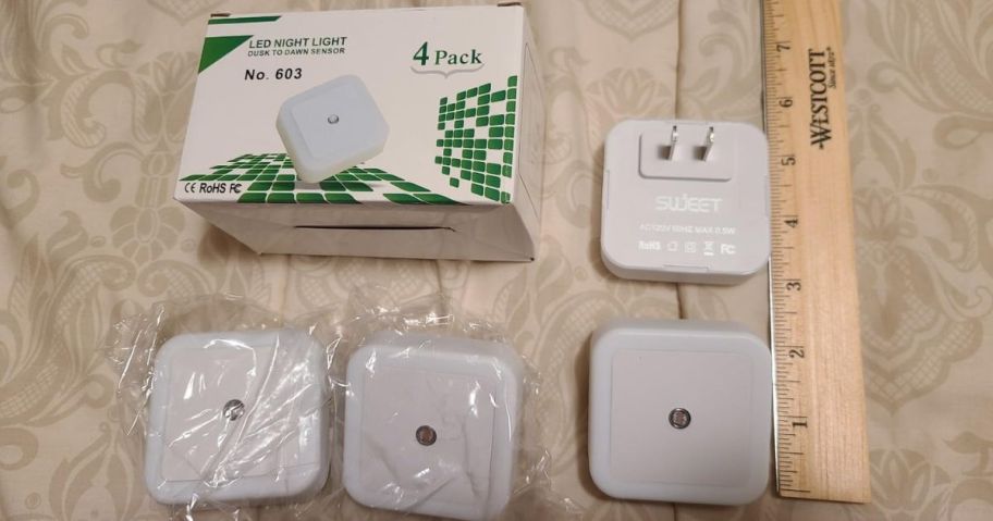 4 pack of square white nightlights shown with box. 