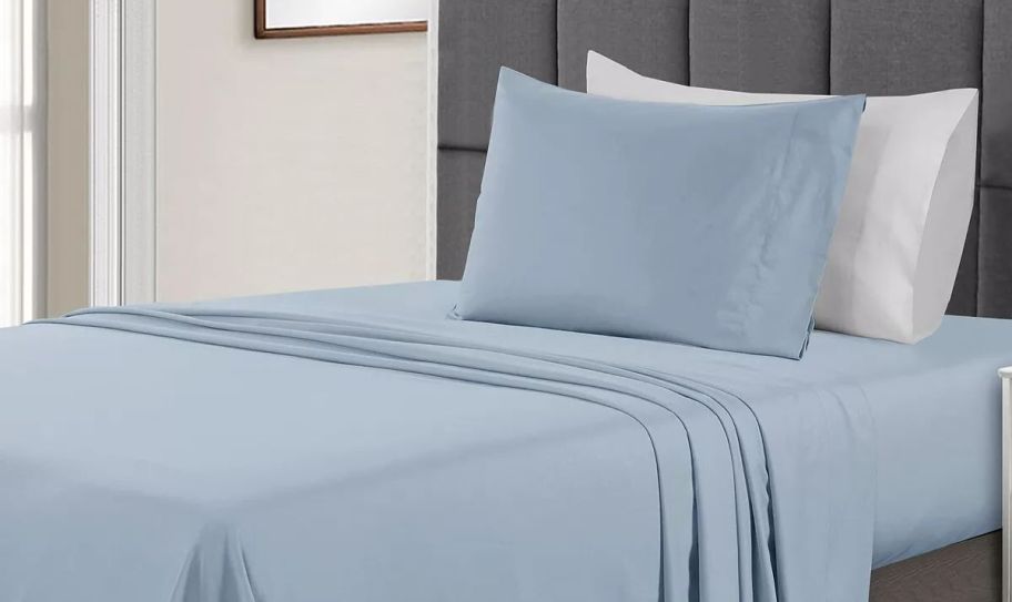 a set of light blue sheets on a twin bed