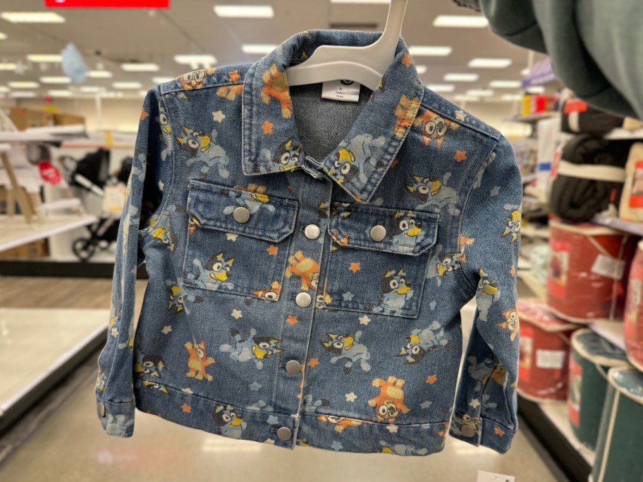 hand holding a toddler size Bluey and Bingo Denim Jacket