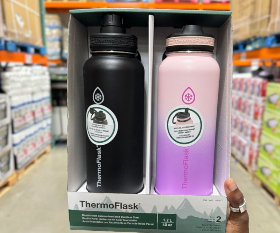 a womans hand holding a thermoflask water bottle 2pack