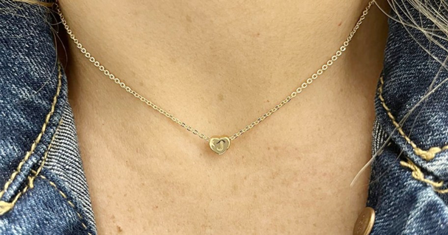 woman wearing gold initial necklace 