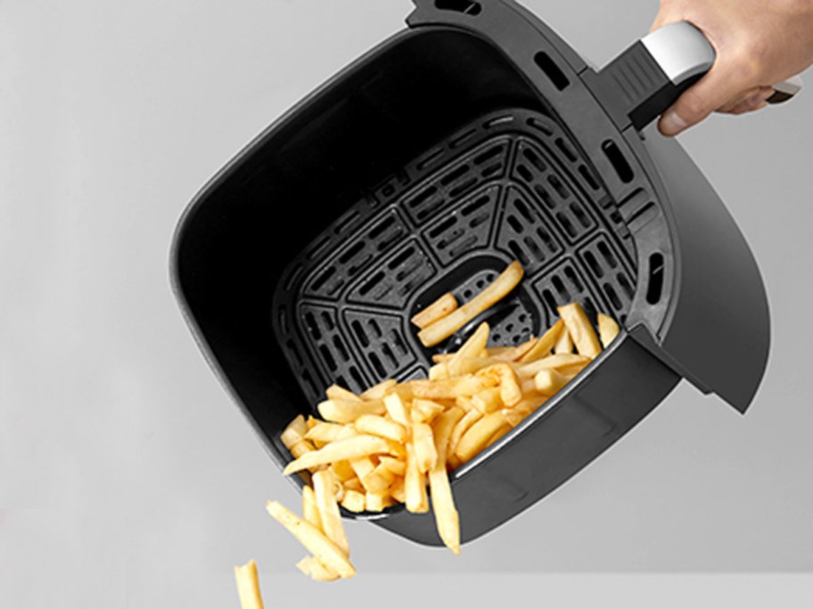 air fryer basket dumping out french fries