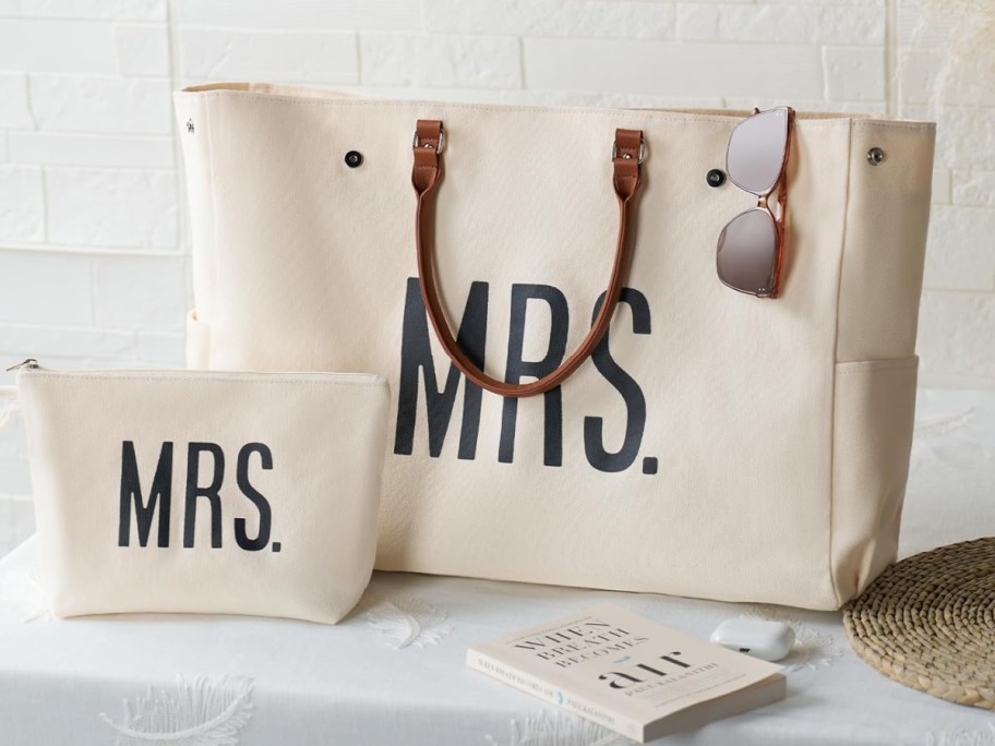 tote and makeup bag set with the words MRS sitting on the table