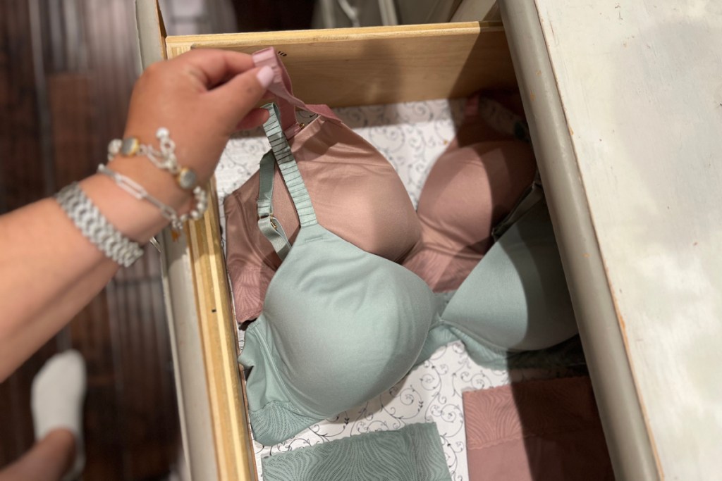 hand grabbing bra out of drawer