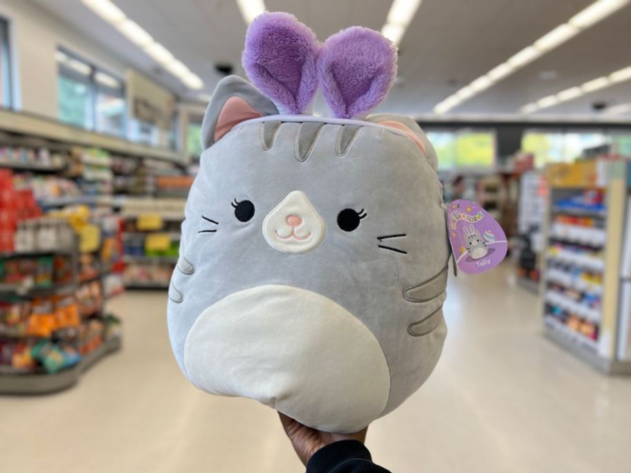 hand holding a grey and white Squishmallows Tally - Tabby Cat with Bunny Ears