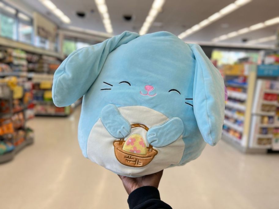 Squishmallows Buttons Bunny Holding Basket plush in person's hand