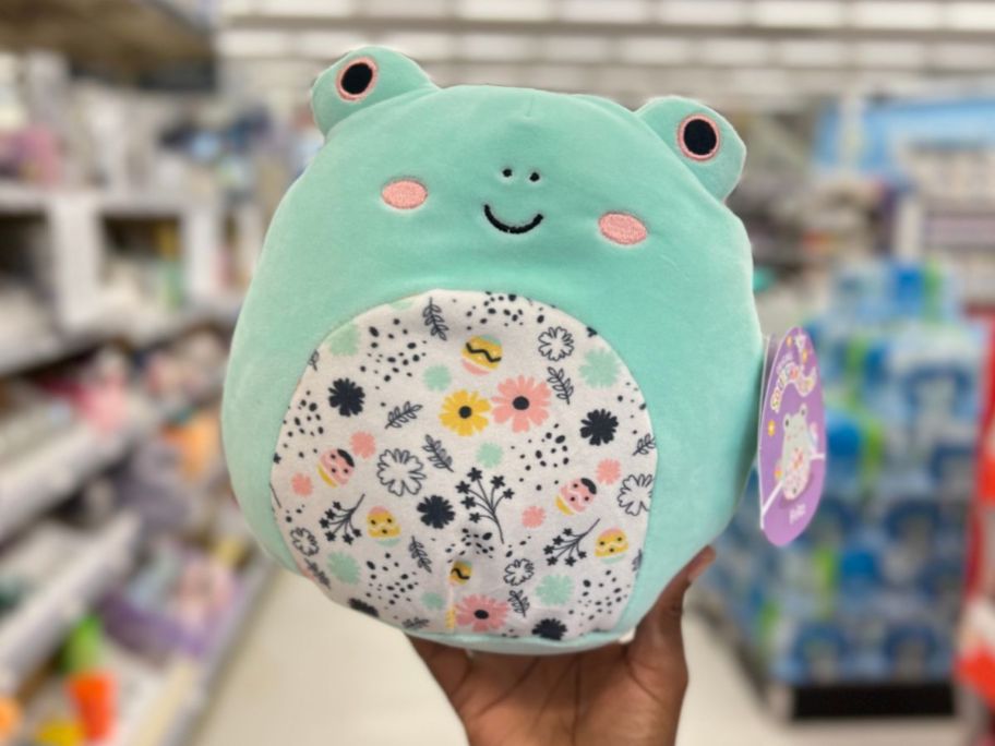 hand holding a green Squishmallows Frog with Floral Belly