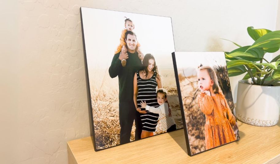 two walgreens wood panel prints on a console table