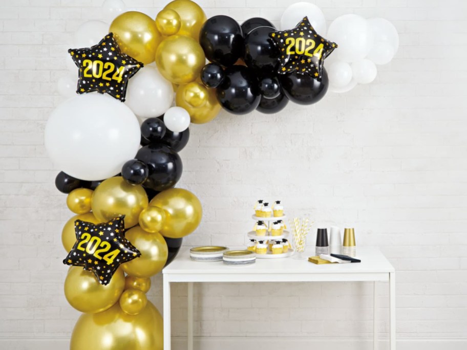 white, black and gold 2024 garland around a table