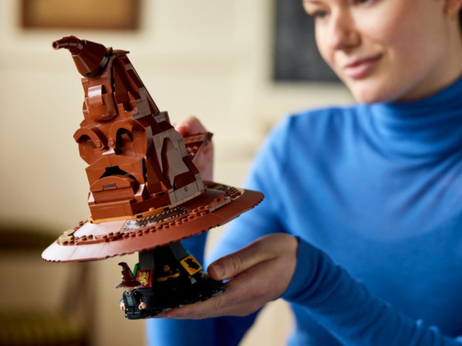 woman playing with new LEGO sorting Hat set