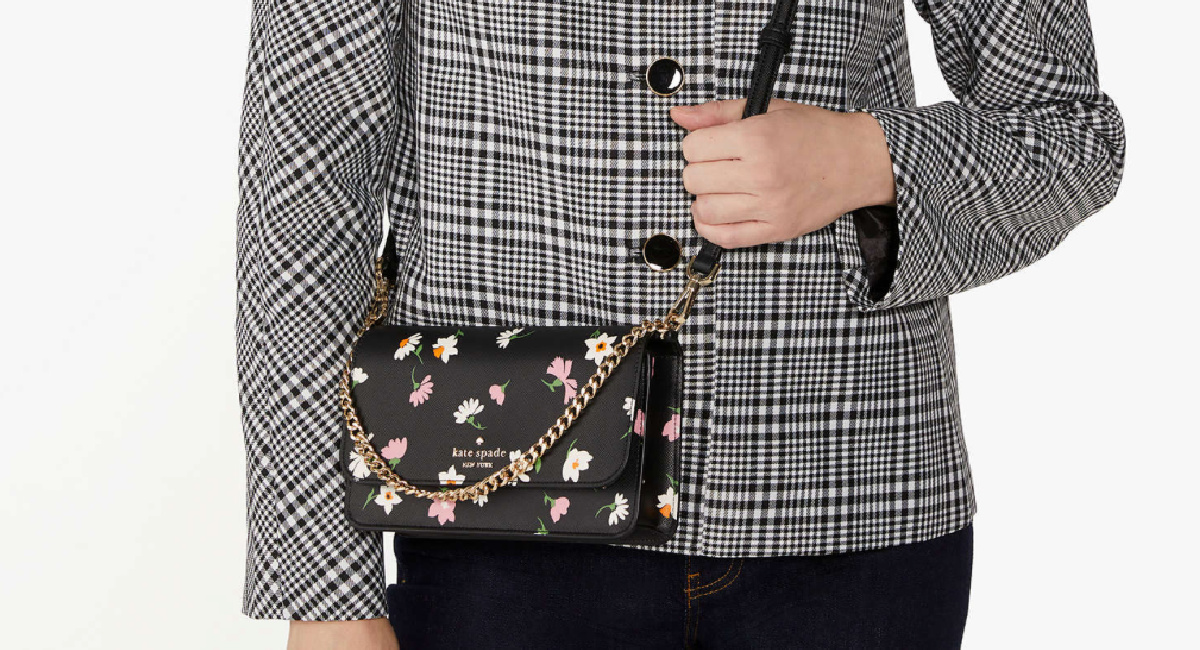 woman wearing a floral Kate spade crossbody handbag