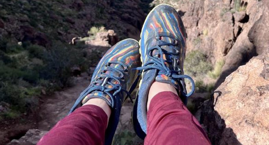 women wearing Merrell sneakers while hiking on a mountain