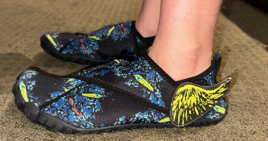 wearing a black pair of water shoes with a colorful pattern