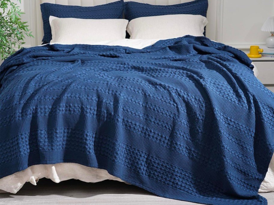 100% Cotton Waffle Weave Throw Blanket on a bed