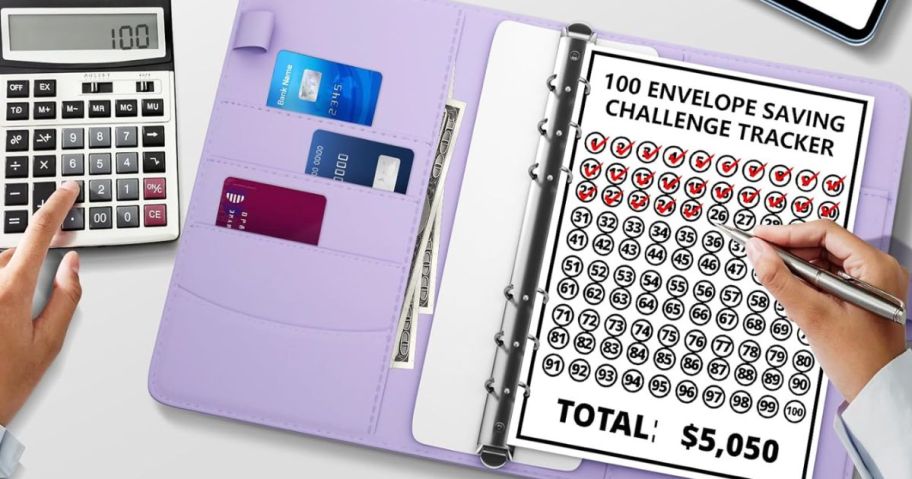 purple money saving binder shown open with the challenge tracking sheet