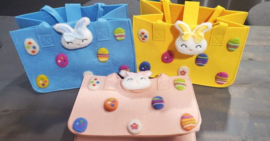 Felt Easter bags in blue, pink and yellow with plush bunnies and eggs on them