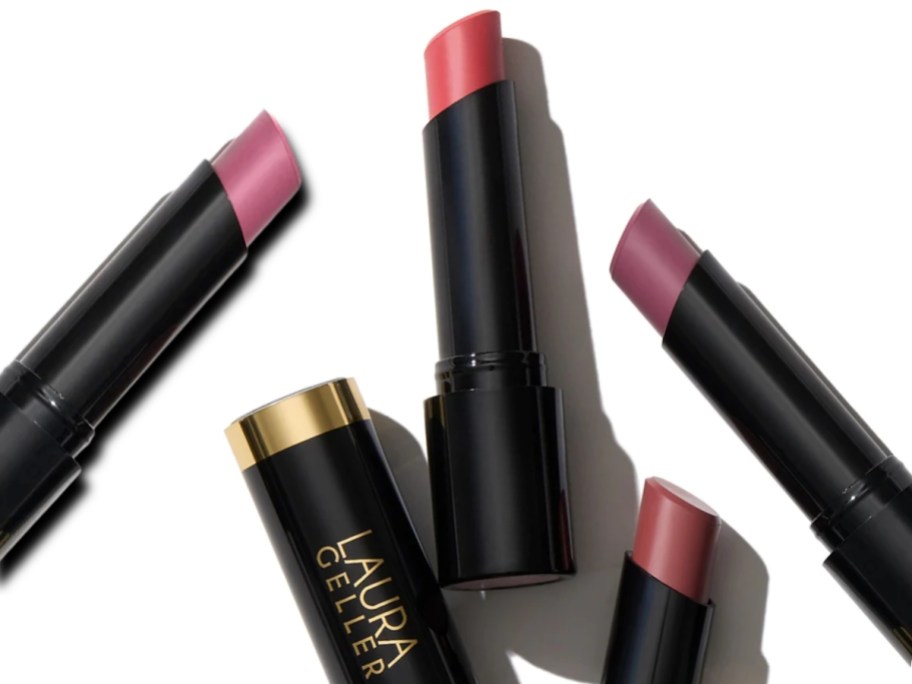 various tubes of Laura Geller lipsticks in different colors