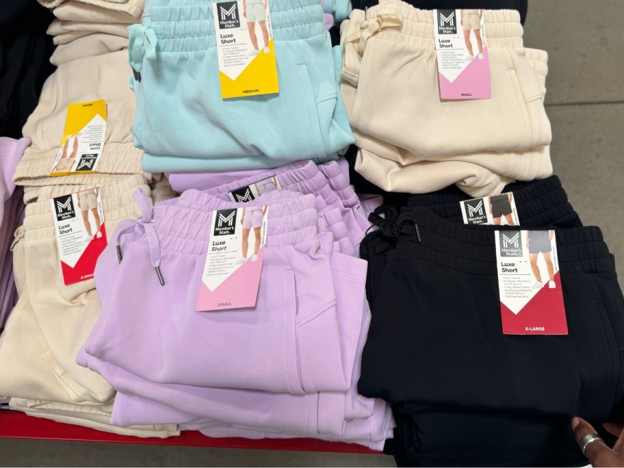 tan, light blue, light purple and black women's shorts on a display table at Sam's Club