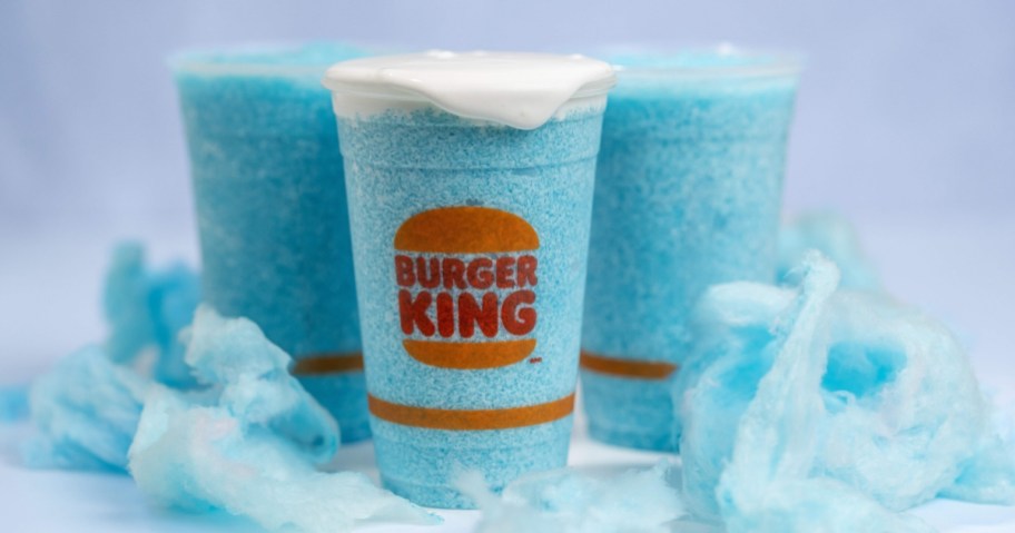 blue burger king frozen cotton candy drinks in burger king cups with blue cotton candy around them
