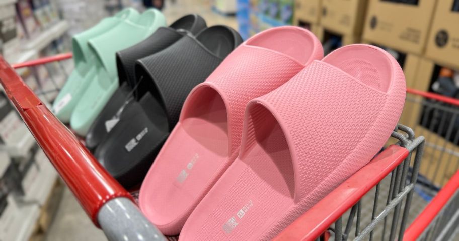 32 Degrees Cushion Slides in pink, black, and teal in a cart