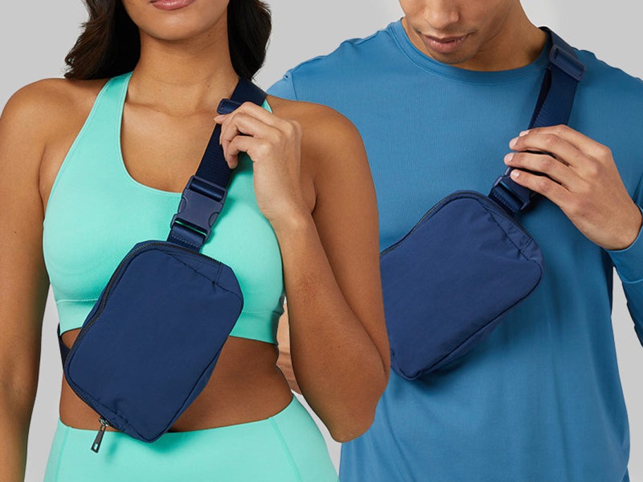 man and woman in teal and blue shirt wearing navy blue belt bags