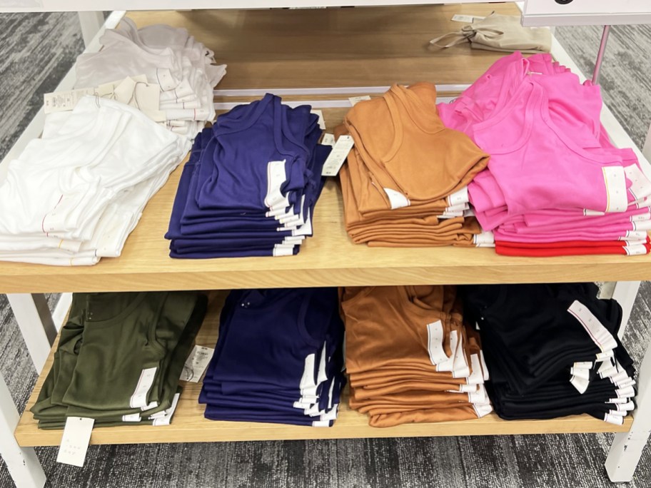 store display shelves with multiple colors of women's tank tops