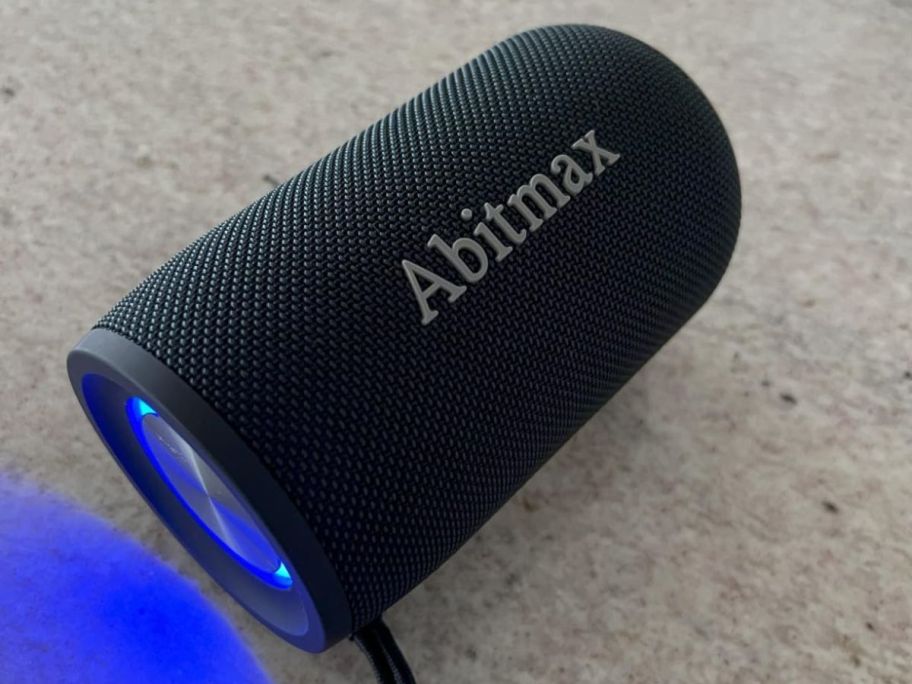 ABitmax Bluetooth Speaker in black with a blue light on