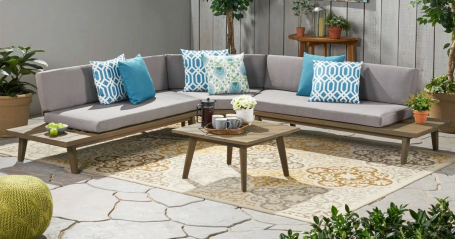 outdoor couch with grey cushions and blue pillows