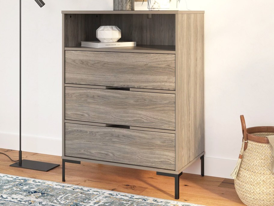 grey 3 drawer dresser with cubby space at the top