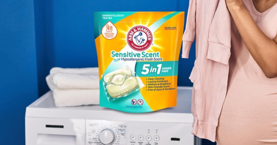 woman using Arm & Hammer Sensitive Scent 5-in-1 Laundry Detergent Power Paks on her laundry