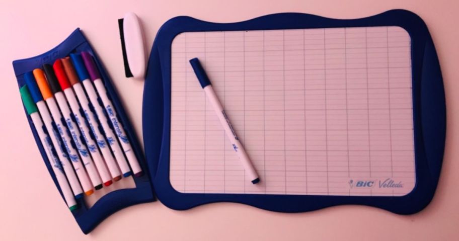 A BIC Dry Erase Board with markers on a table