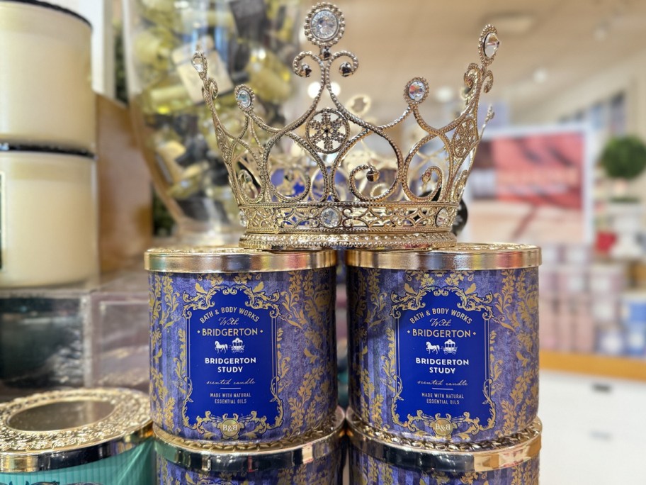 two blue candles with crown on top