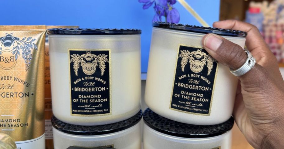 Hand picking up a Bridgerton Candle at Bath & Body Works