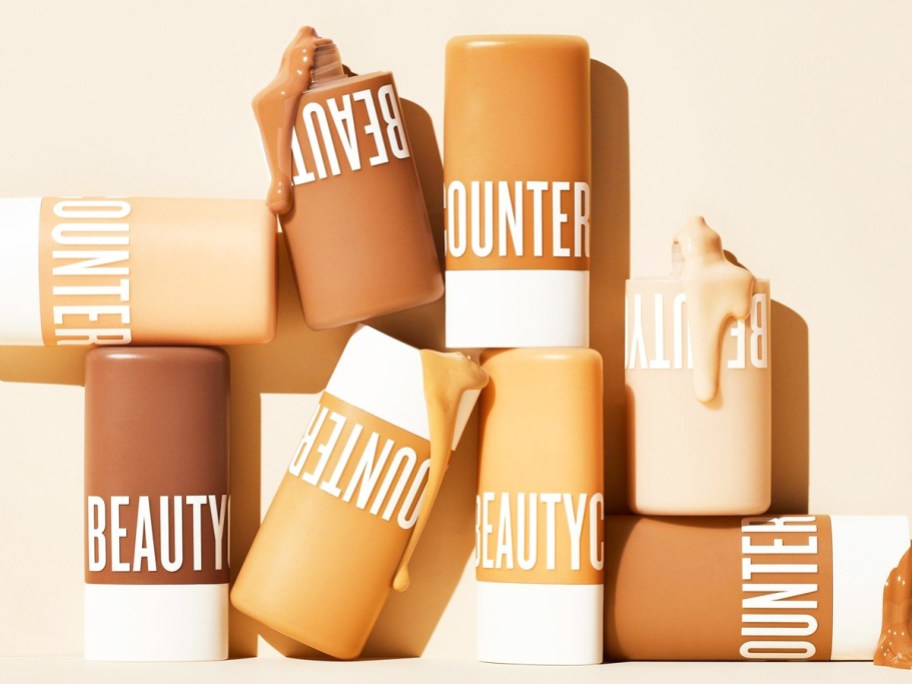 stack of multiple tubes of Beautycounter Dew Skin Tinted Moisturizer in various shades