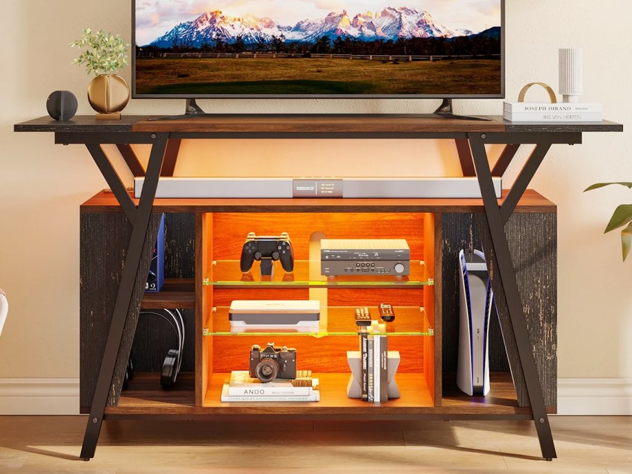 wood and metal tv stand with glass display shelves and lights