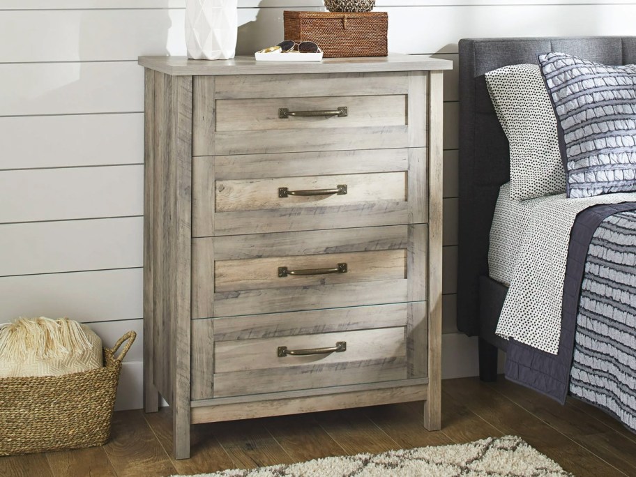 wood 4-drawer dresser next to bed