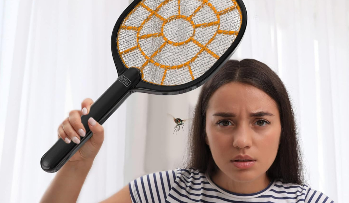 woman holding a Black+Decker Bug Zapper above a fly