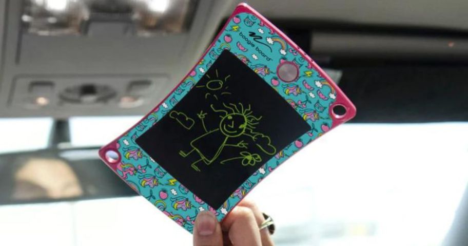 Hand holding up a Boogie Board writing tablet