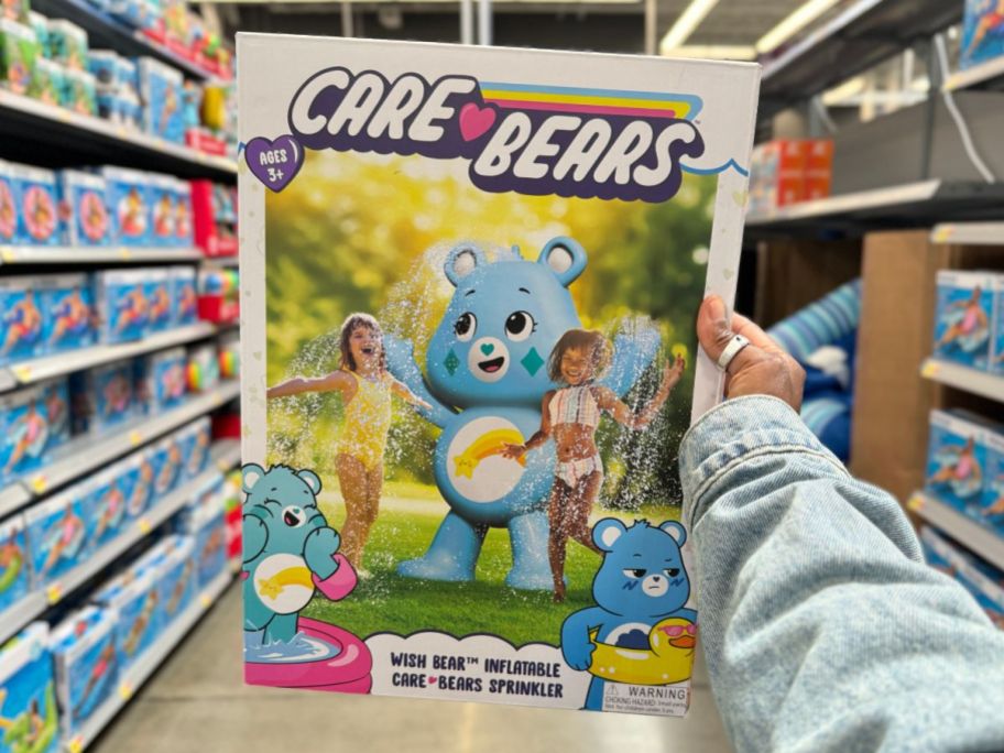A hand holding a Care Bears Wish Bear Inflatable Sprinkler