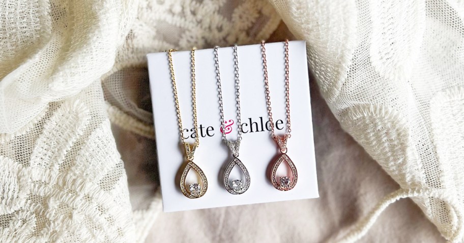 yellow, white, and rose gold necklaces on top of a cate & chloe box